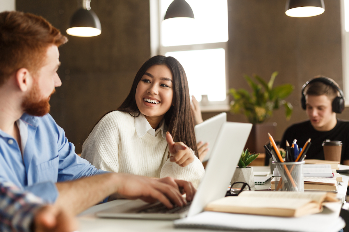 Knowledge Workers Socializing And Discussing Business Matters In A Modern Office